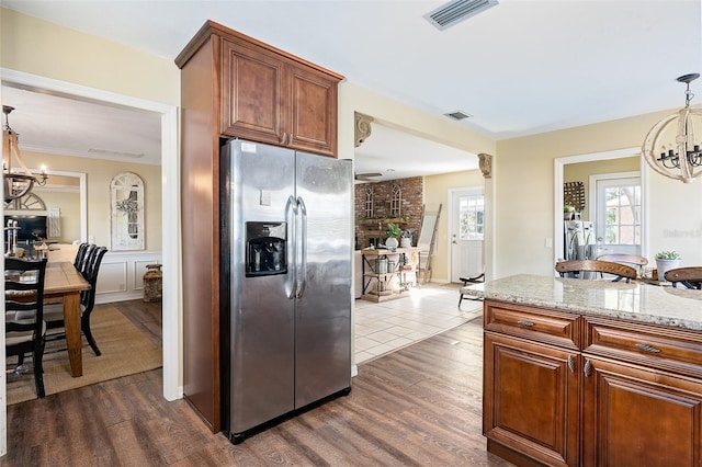 kitchen featuring a chandelier, hanging light fixtures, stainless steel fridge, and dark hardwood / wood-style floors