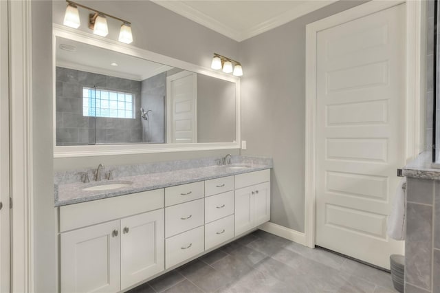 bathroom with vanity, tile patterned flooring, crown molding, and tiled shower