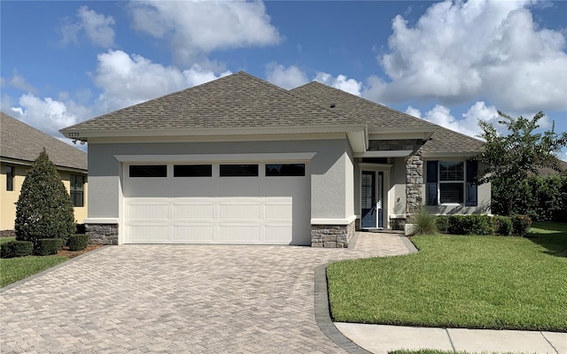 view of front of property featuring a garage and a front lawn