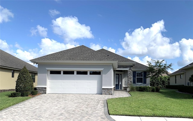 view of front of house featuring a garage and a front lawn