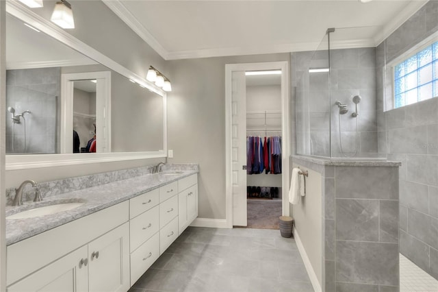 bathroom featuring vanity, crown molding, and a tile shower