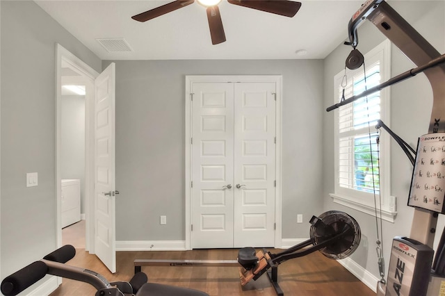 workout area featuring ceiling fan and light hardwood / wood-style flooring