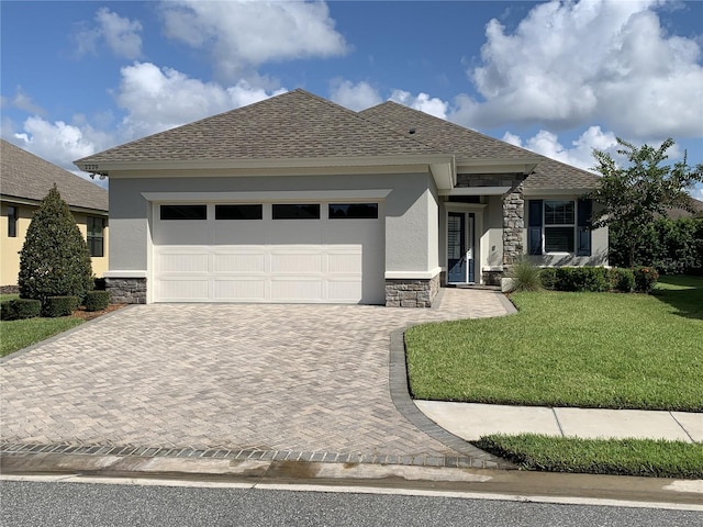 view of front of home featuring a garage and a front yard