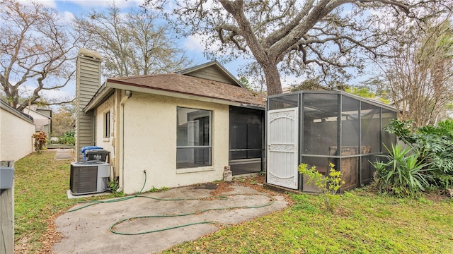 back of house featuring a patio area and central air condition unit