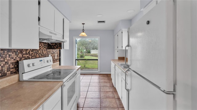 kitchen featuring pendant lighting, premium range hood, tasteful backsplash, white appliances, and white cabinetry