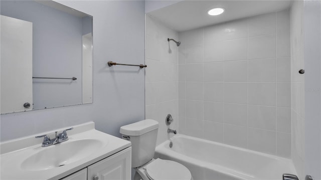 full bathroom featuring tiled shower / bath, toilet, and vanity