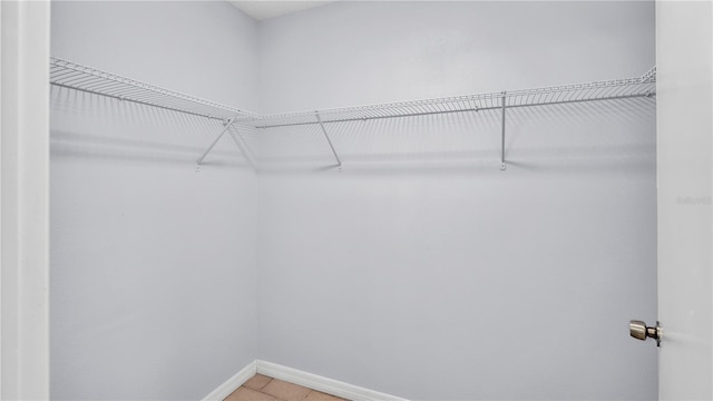 spacious closet featuring light tile floors