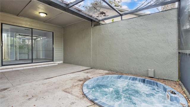 view of terrace featuring an outdoor hot tub