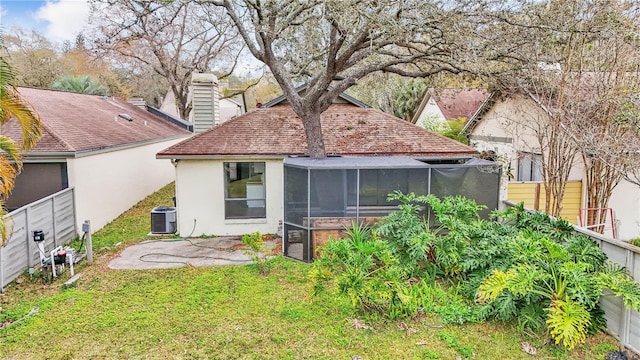 rear view of property featuring a sunroom, central AC, and a patio