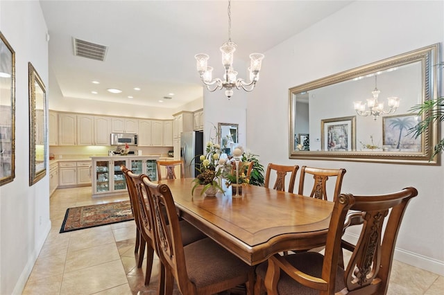 dining space featuring a notable chandelier and light tile floors