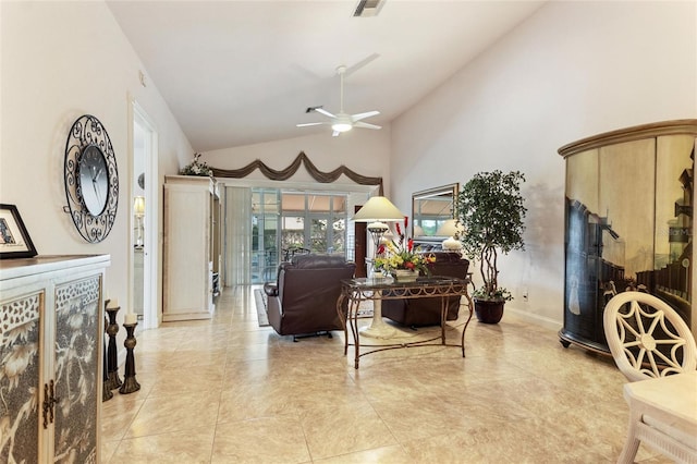 tiled living room featuring ceiling fan and high vaulted ceiling