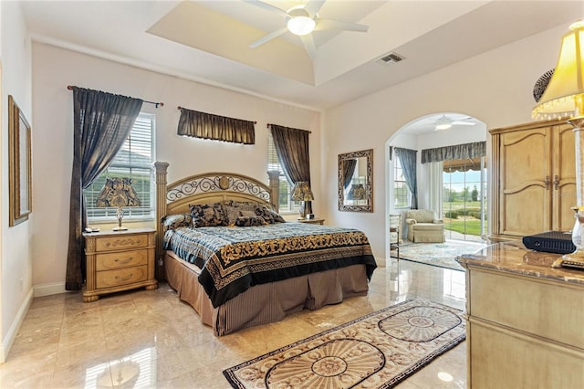 tiled bedroom featuring ceiling fan