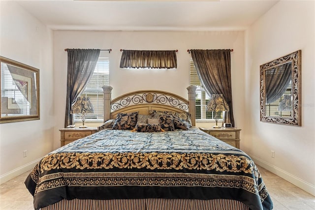 bedroom featuring light tile floors and multiple windows