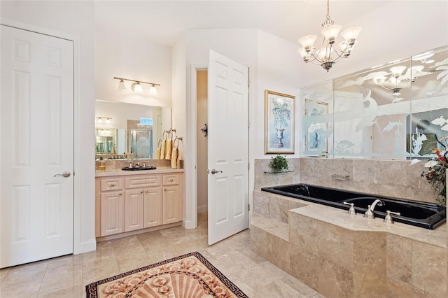 bathroom with tile floors, vanity, a relaxing tiled bath, and a chandelier