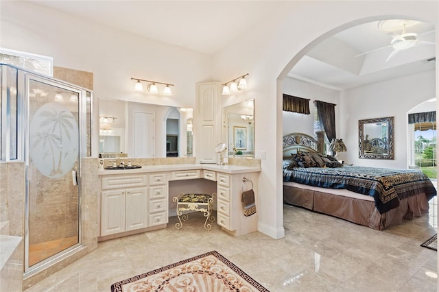 bathroom with tile floors, vanity, and ceiling fan