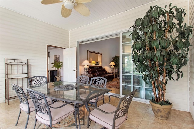 dining space featuring ceiling fan and light tile floors