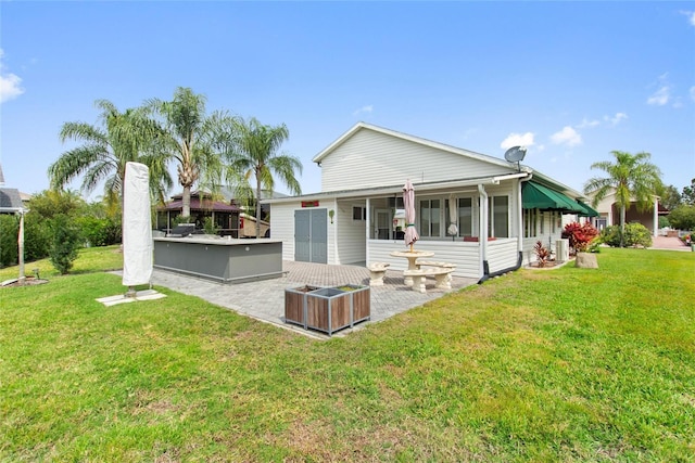 back of property featuring a yard, a gazebo, and a patio