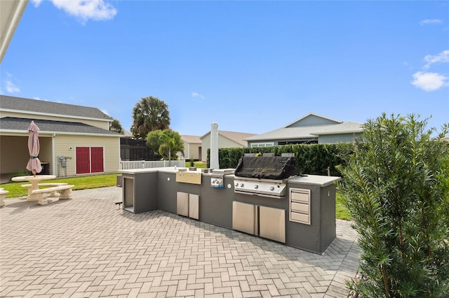 view of patio with area for grilling and exterior kitchen