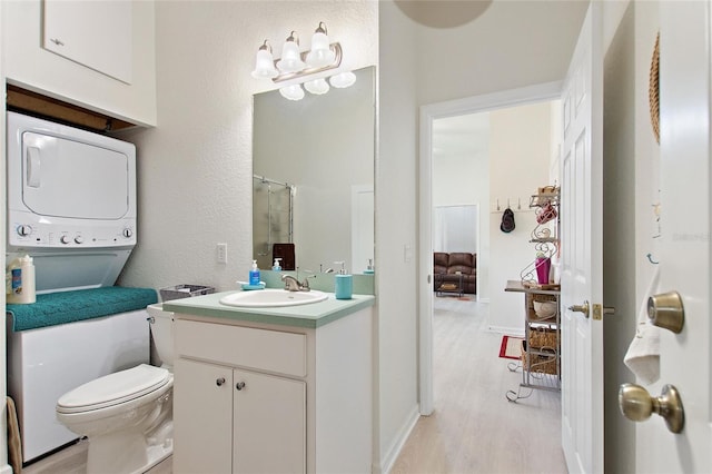 bathroom featuring large vanity, toilet, and wood-type flooring