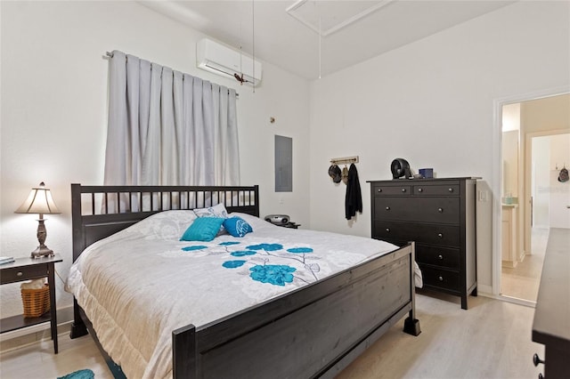 bedroom with light wood-type flooring and an AC wall unit