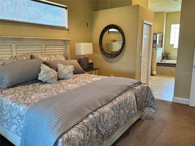 carpeted bedroom featuring ensuite bathroom