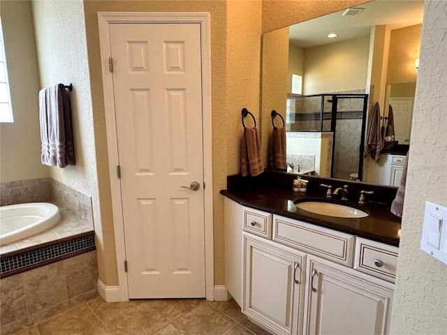 bathroom featuring vanity, shower with separate bathtub, and tile floors