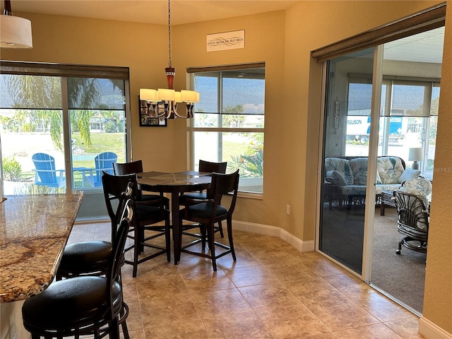 tiled dining space featuring a notable chandelier