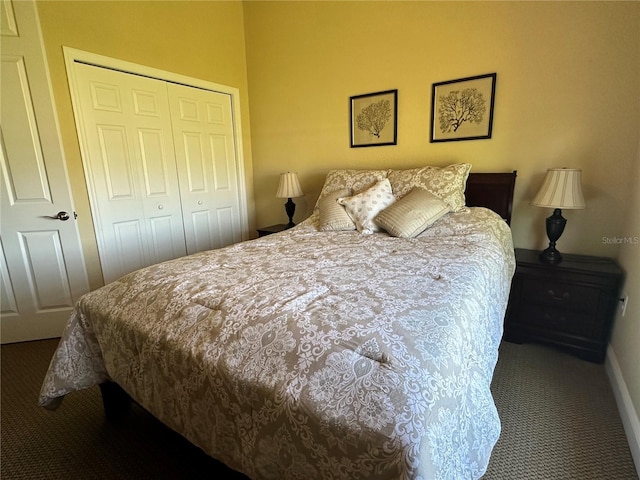 bedroom featuring a closet and dark carpet