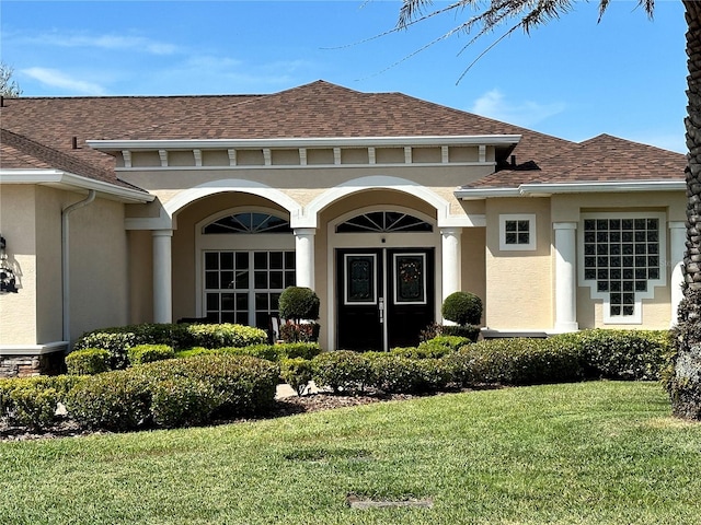 entrance to property with a lawn