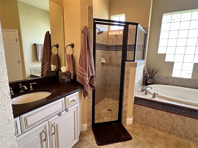 bathroom with tile floors, separate shower and tub, and large vanity