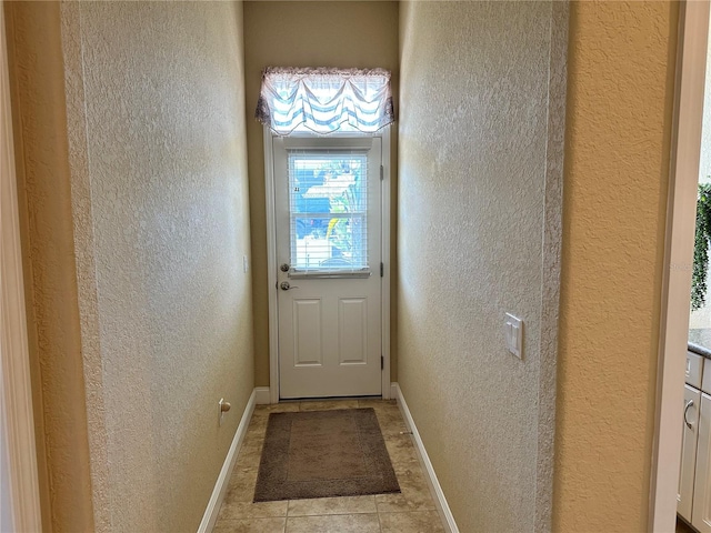 doorway with light tile floors