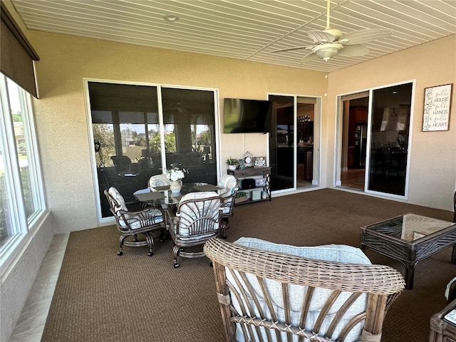 sunroom / solarium featuring ceiling fan