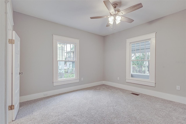 empty room featuring light carpet and ceiling fan