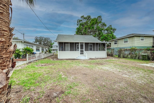 rear view of property with a sunroom