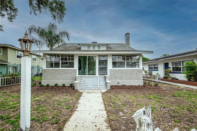 view of front of house featuring a sunroom