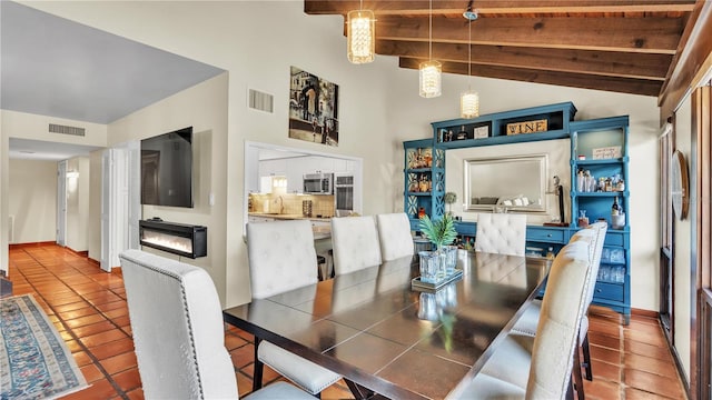 tiled dining room with a towering ceiling, wooden ceiling, sink, and beamed ceiling