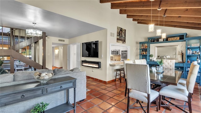 tiled dining room featuring an inviting chandelier and beam ceiling