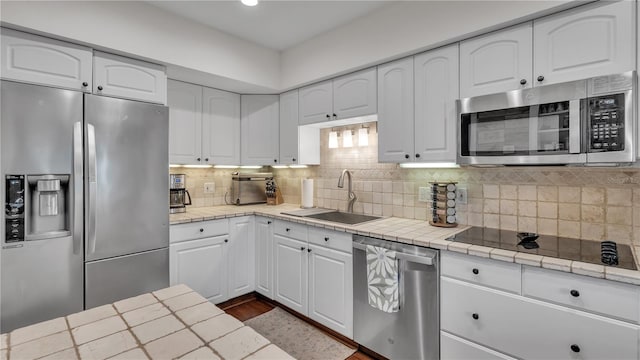 kitchen featuring white cabinetry, tasteful backsplash, sink, and stainless steel appliances