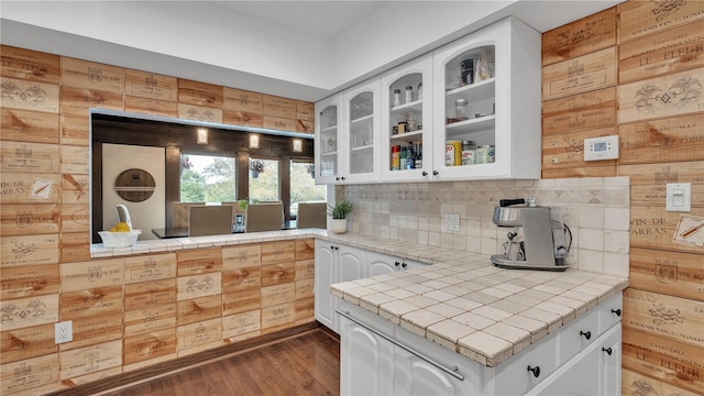 kitchen featuring white cabinets, backsplash, tile countertops, and dark hardwood / wood-style flooring