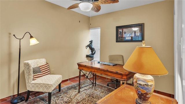 office space featuring ceiling fan and dark tile flooring