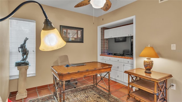 tiled office space with plenty of natural light and ceiling fan