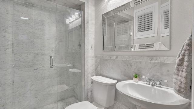 bathroom with tile walls, walk in shower, toilet, sink, and tasteful backsplash