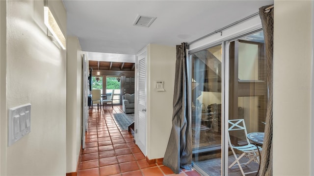 hallway with dark tile flooring