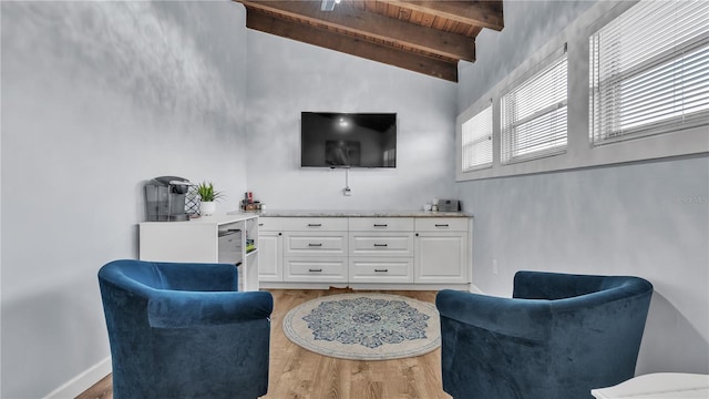 sitting room featuring wood ceiling, high vaulted ceiling, light wood-type flooring, and beamed ceiling