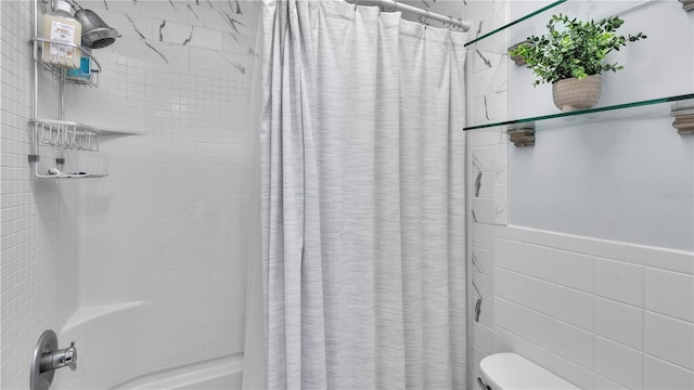 bathroom featuring shower / bath combination with curtain, toilet, and tile walls