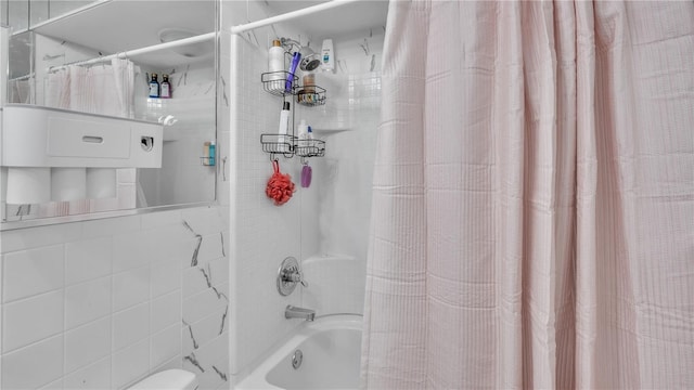 bathroom featuring toilet and shower / bath combo with shower curtain