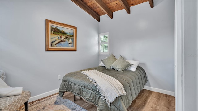 bedroom with dark wood-type flooring, wooden ceiling, and lofted ceiling with beams