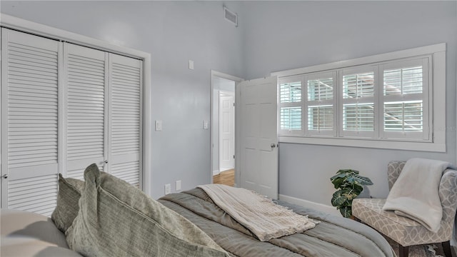 bedroom with hardwood / wood-style floors and a closet