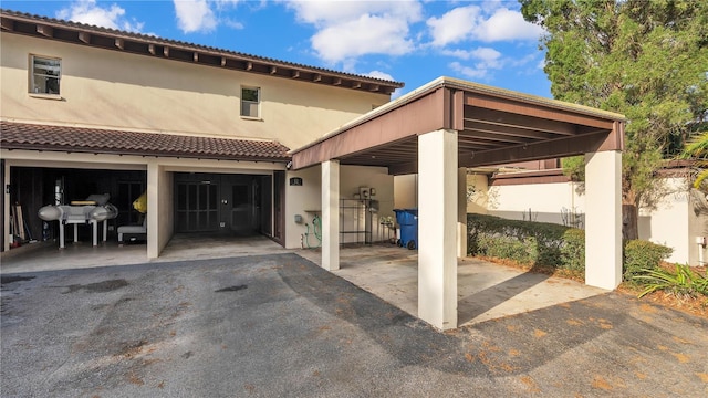 exterior space with a garage and a carport