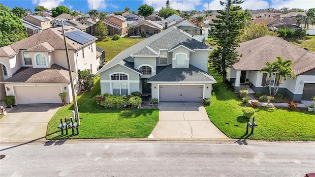 view of front of property with a front lawn and a garage